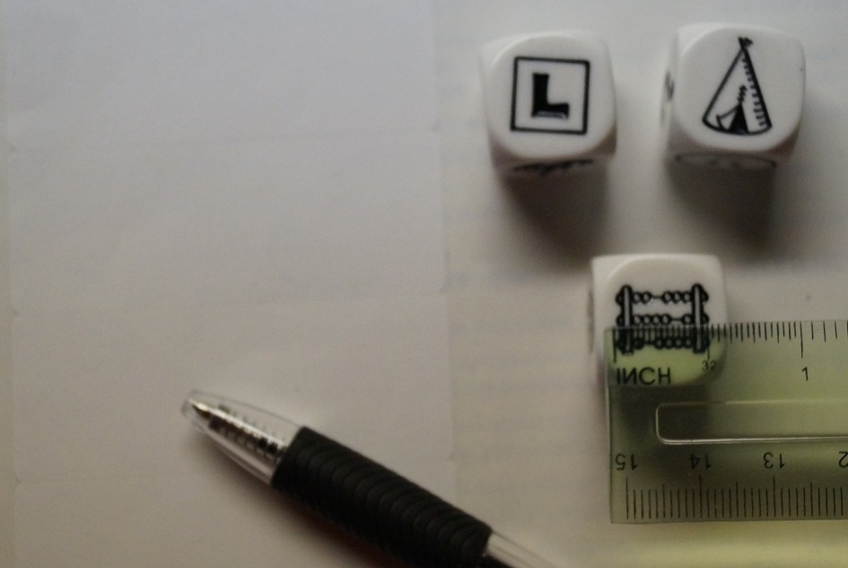 three story cubes, a ruler, a pen and some white stickers