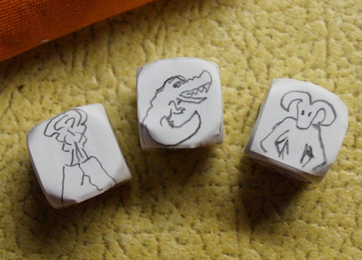 Three story cubes with hand-drawn symbols