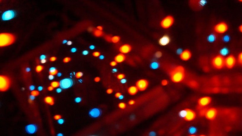Orange and blue lights reflected in a room of mirrors.