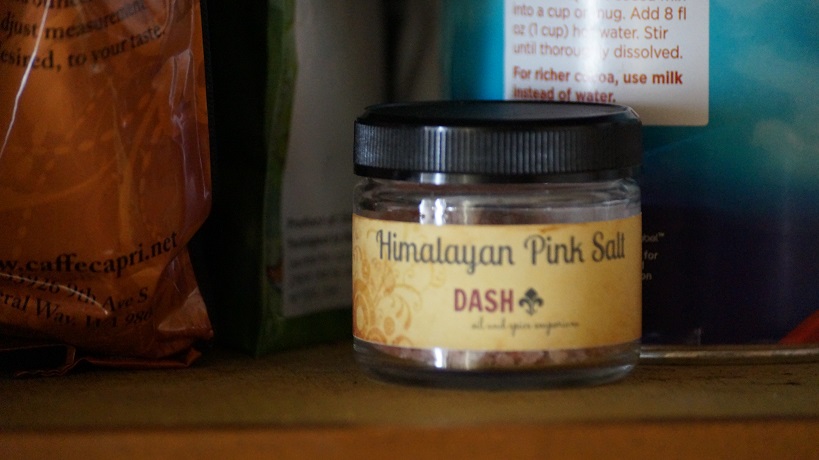 A photograph of a small jar of Himalayan Pink Salt on a shelf.
