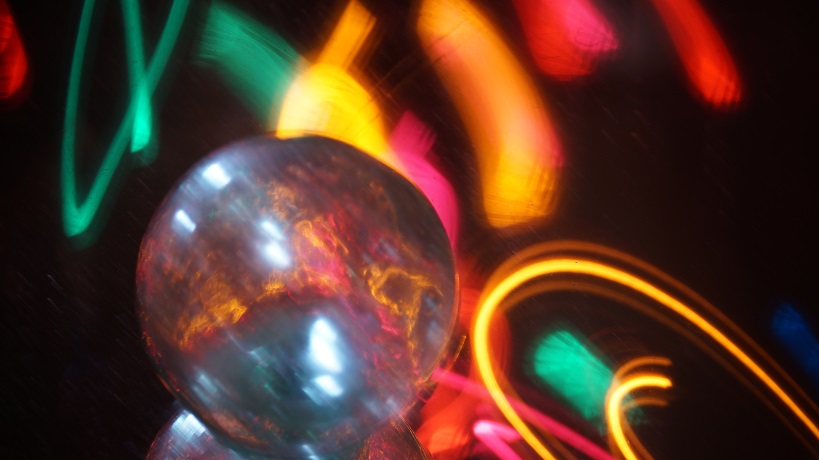 A glass ball surrounded by colored lights.